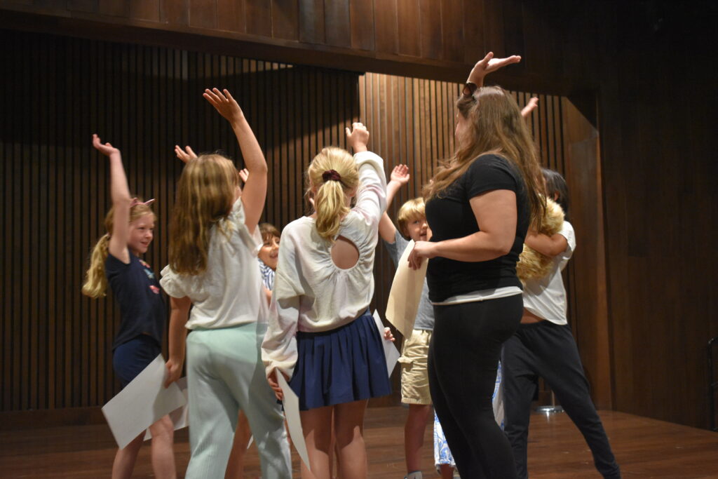 Youth on stage high five eachother