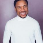 Headshot of Sharief Johnson grinning for the camera.