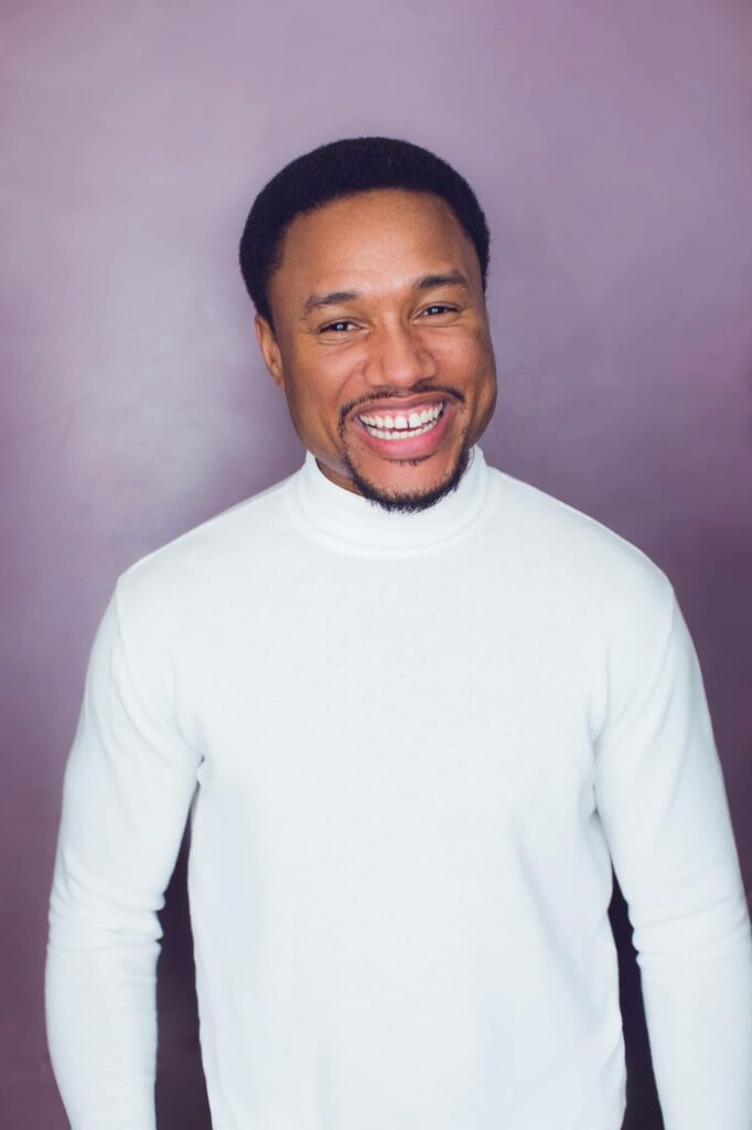 Headshot of Sharief Johnson grinning for the camera.