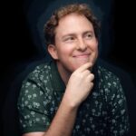 Headshot of Jesse Eigner holding his chin while not looking at the camera.