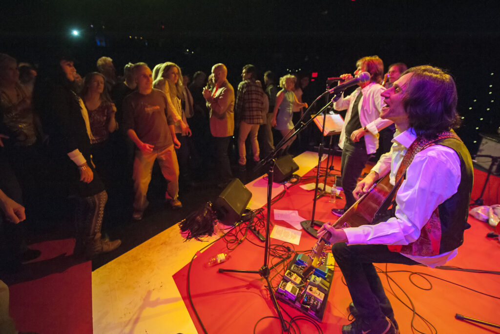 a band performing in front of a live audience