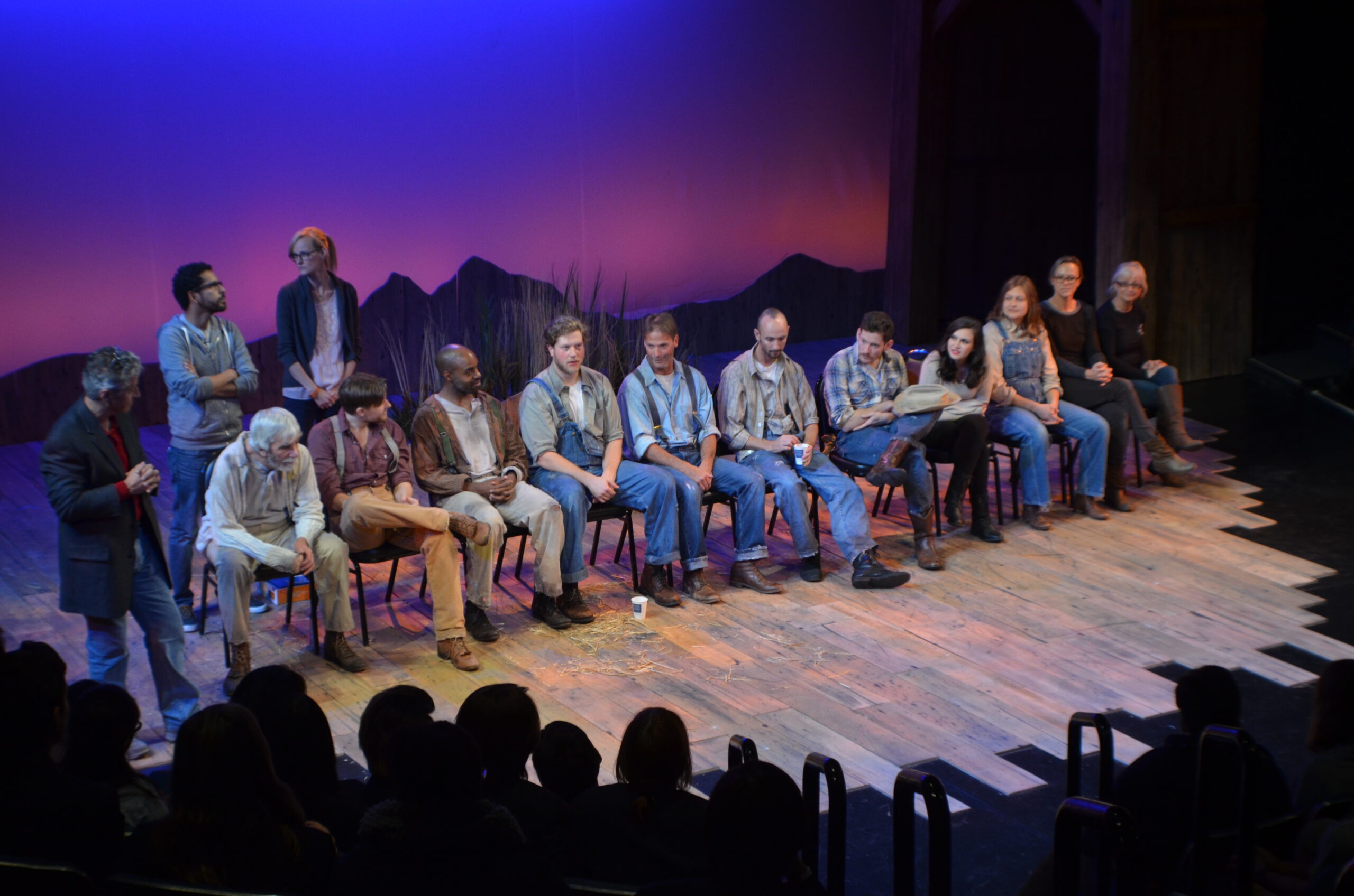 many people sitting stage talking