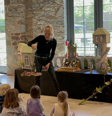 Kim Profacci performs for a crowd of children using a marionette
